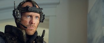 Movie still from “Elysium” (2013), directed by Neill Blomkamp – A person wearing a helmet; Close Up shot, Over the shoulder angle