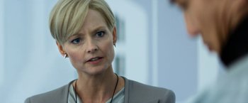 Movie still from “Elysium” (2013), directed by Neill Blomkamp – A person wearing a suit; Close Up shot, Over the shoulder angle