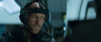 Movie still from “Elysium” (2013), directed by Neill Blomkamp – A person wearing a helmet; Close Up shot, Over the shoulder angle
