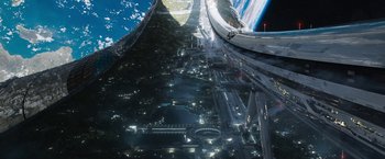 Movie still from “Elysium” (2013), directed by Neill Blomkamp – An aerial view of a city at night with lights; Extreme Wide shot, Overhead angle