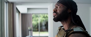 Movie still from “Elysium” (2013), directed by Neill Blomkamp – A person with a beard looking up; Close Up shot, Low angle