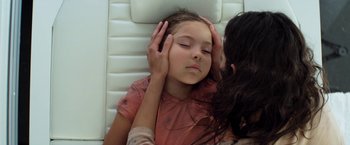 Movie still from “Elysium” (2013), directed by Neill Blomkamp – A young girl laying on a bed with her head on a pillow; Close Up shot, Overhead angle