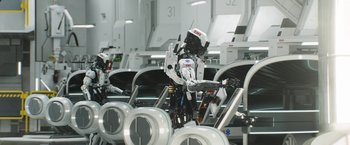 Movie still from “Elysium” (2013), directed by Neill Blomkamp – A group of robots in a room next to each other; Wide shot, Low angle