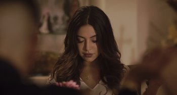 Movie still from “The Tax Collector” (2020), directed by David Ayer – A beautiful young lady holding a pink flower in her hand; Close Up shot, Over the shoulder angle