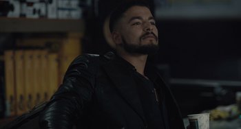 Movie still from “The Tax Collector” (2020), directed by David Ayer – A man in a black jacket is looking up; Close Up shot, Low angle