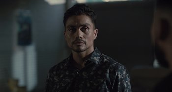 Movie still from “The Tax Collector” (2020), directed by David Ayer – A person wearing a camouflage shirt; Close Up shot, Over the shoulder angle