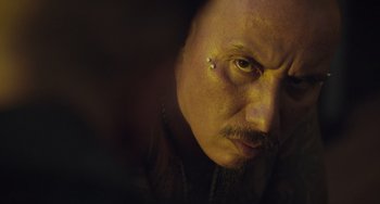 Movie still from “The Tax Collector” (2020), directed by David Ayer – A person with a piercing on his ear; Close Up shot, Over the shoulder angle