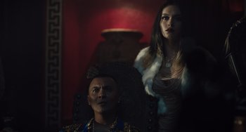 Movie still from “The Tax Collector” (2020), directed by David Ayer – A man and a woman are sitting in a chair; Medium shot, Low angle