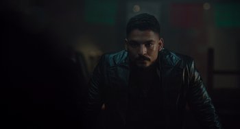 Movie still from “The Tax Collector” (2020), directed by David Ayer – A person wearing a black jacket; Close Up shot, Low angle