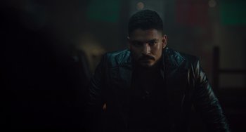 Movie still from “The Tax Collector” (2020), directed by David Ayer – A person wearing a leather jacket; Close Up shot, Low angle