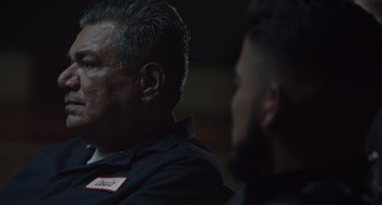Movie still from “The Tax Collector” (2020), directed by David Ayer – Two men sitting in front of each other; Close Up shot, Over the shoulder angle