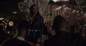 Movie still from “The Tax Collector” (2020), directed by David Ayer – A woman standing in front of a group of people; Medium shot, Over the shoulder angle