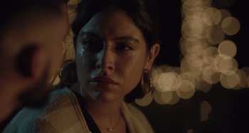 Movie still from “The Tax Collector” (2020), directed by David Ayer – A young woman with tears in her eyes; Close Up shot, Over the shoulder angle