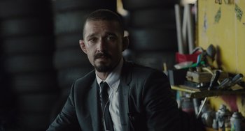 Movie still from “The Tax Collector” (2020), directed by David Ayer – A person wearing a suit and tie; Close Up shot, Over the shoulder angle