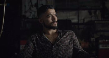 Movie still from “The Tax Collector” (2020), directed by David Ayer – A man with a goatee is looking up at the ceiling; Close Up shot, Low angle