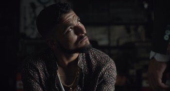 Movie still from “The Tax Collector” (2020), directed by David Ayer – A person with a beard looking up; Close Up shot, Low angle