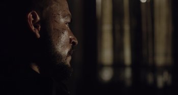 Movie still from “The Tax Collector” (2020), directed by David Ayer – A person with a beard; Close Up shot, Over the shoulder angle