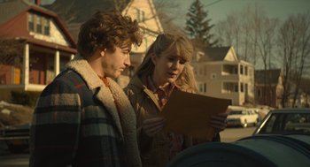 Movie still from “The Tender Bar” (2021), directed by George Clooney – A man and a woman standing next to each other looking at a piece of paper; Close Up shot, Over the shoulder angle