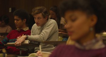 Movie still from “The Tender Bar” (2021), directed by George Clooney – A group of people sitting in a room; Medium shot, Over the shoulder angle
