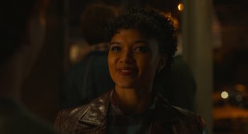 Movie still from “The Tender Bar” (2021), directed by George Clooney – A person wearing a leather jacket; Close Up shot, Over the shoulder angle