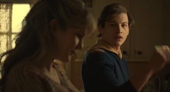 Movie still from “The Tender Bar” (2021), directed by George Clooney – A man and a woman are standing next to each other; Close Up shot, Over the shoulder angle