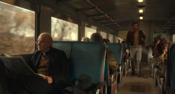 Movie still from “The Tender Bar” (2021), directed by George Clooney – A group of people riding on a train; Wide shot, Over the shoulder angle