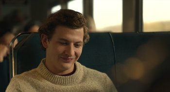 Movie still from “The Tender Bar” (2021), directed by George Clooney – A man sitting in a chair with his eyes closed; Close Up shot, Over the shoulder angle