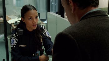 Movie still from “The Terminal” (2004), directed by Steven Spielberg – A police officer talking to a man in a suit; Close Up shot, Over the shoulder angle