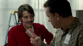 Movie still from “The Terminal” (2004), directed by Steven Spielberg – Two men are playing a video game together; Close Up shot, Over the shoulder angle