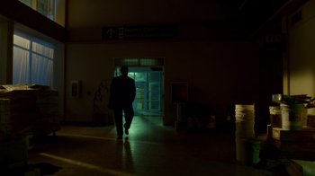 Movie still from “The Terminal” (2004), directed by Steven Spielberg – Two people walking down a dark hallway at night; Wide shot, Low angle