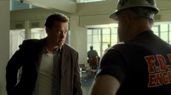 Movie still from “The Terminal” (2004), directed by Steven Spielberg – Two men are talking in an open room; Medium shot, Over the shoulder angle