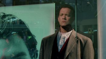 Movie still from “The Terminal” (2004), directed by Steven Spielberg – A man wearing a suit and tie standing in front of a window; Close Up shot, Low angle