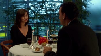 Movie still from “The Terminal” (2004), directed by Steven Spielberg – A man and a woman sitting at a dinner table; Medium shot, Over the shoulder angle