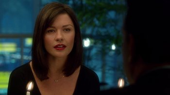 Movie still from “The Terminal” (2004), directed by Steven Spielberg – A woman with red lipstick is talking to a man; Close Up shot, Over the shoulder angle