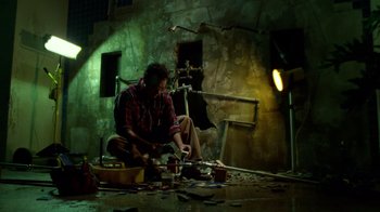Movie still from “The Terminal” (2004), directed by Steven Spielberg – A man sitting on the ground in a room; Wide shot, Low angle