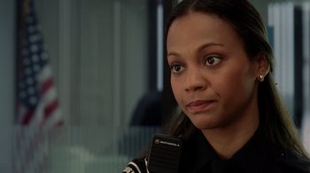 Movie still from “The Terminal” (2004), directed by Steven Spielberg – A woman that is sitting in front of a microphone; Close Up shot, Over the shoulder angle