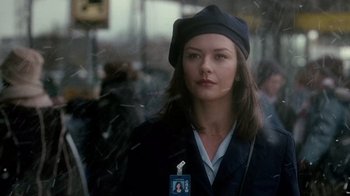 Movie still from “The Terminal” (2004), directed by Steven Spielberg – A woman with a hat and a name tag; Close Up shot, Over the shoulder angle