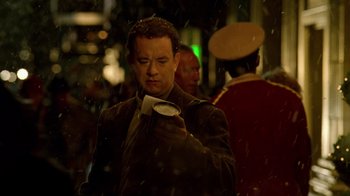 Movie still from “The Terminal” (2004), directed by Steven Spielberg – A man in a suit holding a coffee cup; Close Up shot, Low angle