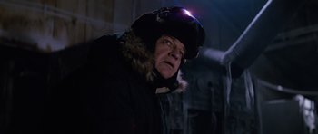 Movie still from “The Thing” (1982), directed by John Carpenter – A man wearing a winter coat and a hat with a light on it; Close Up shot, Low angle