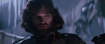 Movie still from “The Thing” (1982), directed by John Carpenter – A man with a beard wearing a brown jacket; Close Up shot, Low angle