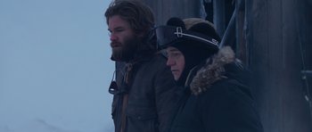 Movie still from “The Thing” (1982), directed by John Carpenter – Two men standing next to each other in the snow; Medium shot, Low angle