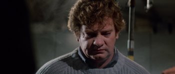Movie still from “The Thing” (1982), directed by John Carpenter – A person wearing a sweater; Close Up shot, Low angle