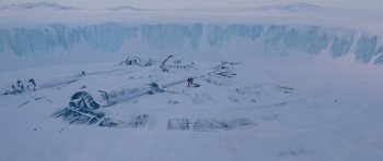 Movie still from “The Thing” (1982), directed by John Carpenter – Two people standing on top of a snow covered slope; Extreme Wide shot, High angle