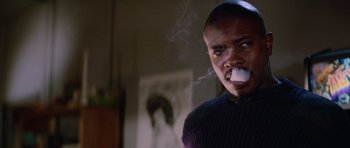 Movie still from “The Thing” (1982), directed by John Carpenter – A man smoking a cigarette while wearing a sweater; Close Up shot, Low angle