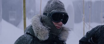 Movie still from “The Thing” (1982), directed by John Carpenter – A person wearing a hat and goggles in the snow; Close Up shot, Low angle