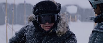 Movie still from “The Thing” (1982), directed by John Carpenter – A person wearing a winter hat and goggles; Close Up shot, Over the shoulder angle