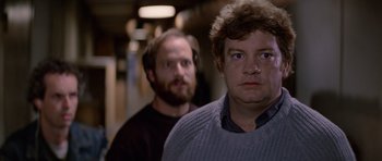 Movie still from “The Thing” (1982), directed by John Carpenter – Two men standing next to each other in front of a wall; Close Up shot, Over the shoulder angle