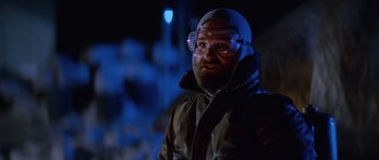 Movie still from “The Thing” (1982), directed by John Carpenter – A man with a beard wearing goggles and a jacket; Close Up shot, Low angle