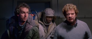 Movie still from “The Thing” (1982), directed by John Carpenter – A group of men standing next to each other; Close Up shot, Low angle