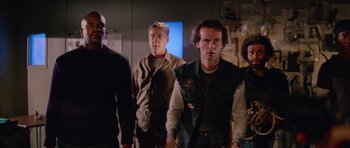 Movie still from “The Thing” (1982), directed by John Carpenter – A group of people standing in a room; Medium shot, Low angle